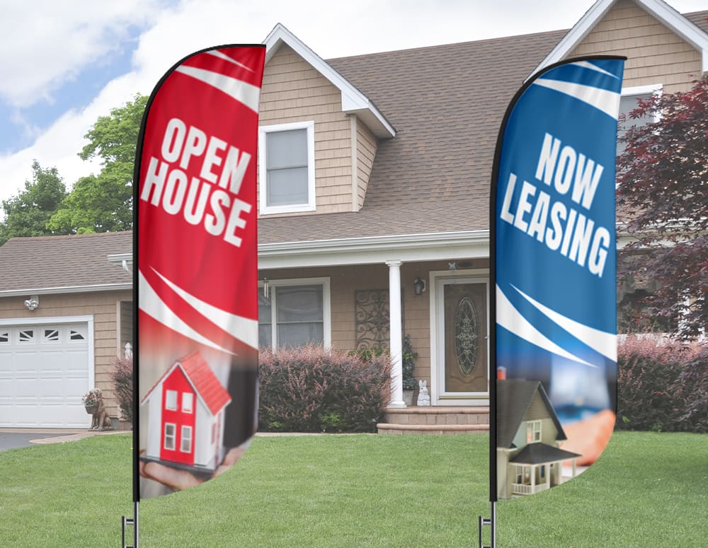 Two Feather Flag Nation feather flags reading Open House and Now Leasing in front of a suburban house