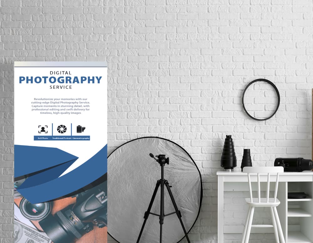 A roll-up banner for a photography service standing in a bright studio