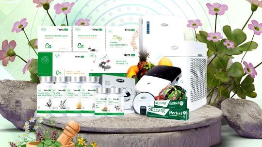 Tiens Pakistan product range: food supplement jars, devices and household items on a display stage